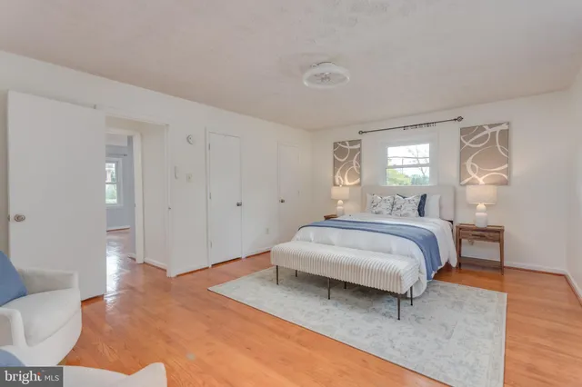 a spacious bedroom with a bed and a couch