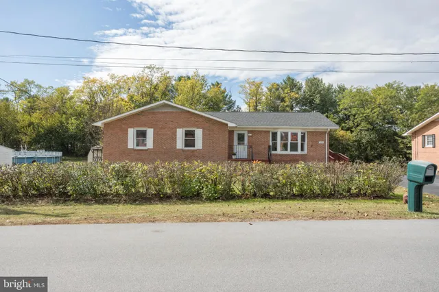 a aerial view of a house with swimming pool next to a yard