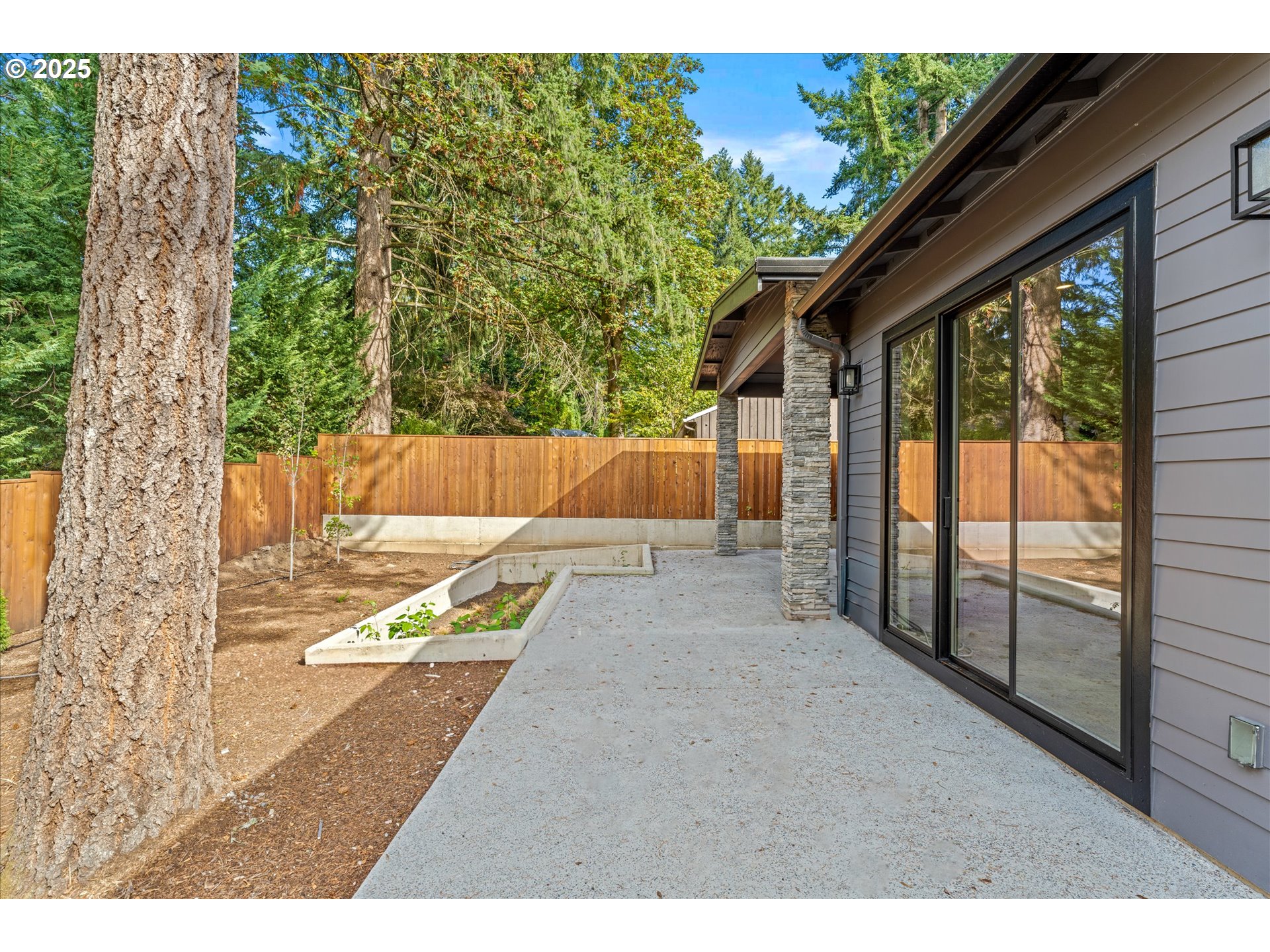 15003 Twin Fir Road Lake Oswego, OR 97035 - Photo 40 of 42 a view of a backyard with a large tree and wooden fence