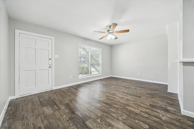 wooden floor in an empty room with a window