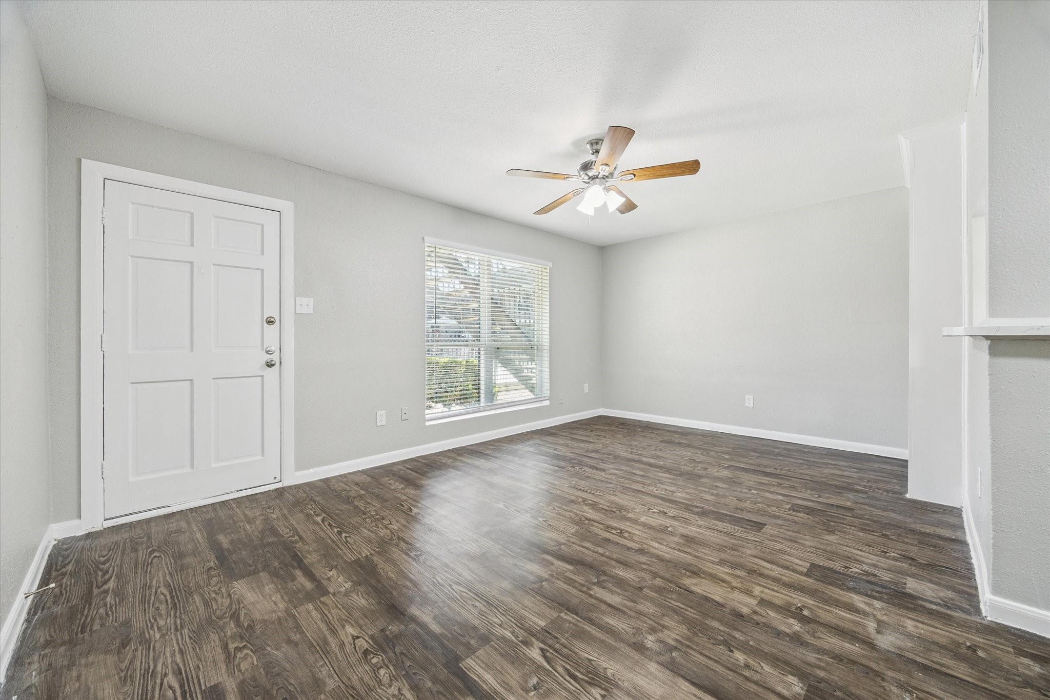 wooden floor in an empty room with a window