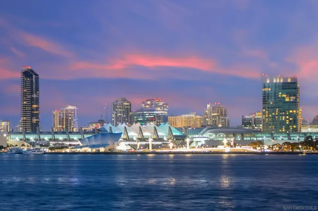 a view of a city with tall buildings and a lake
