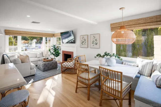 a living room with furniture a fireplace and a large window