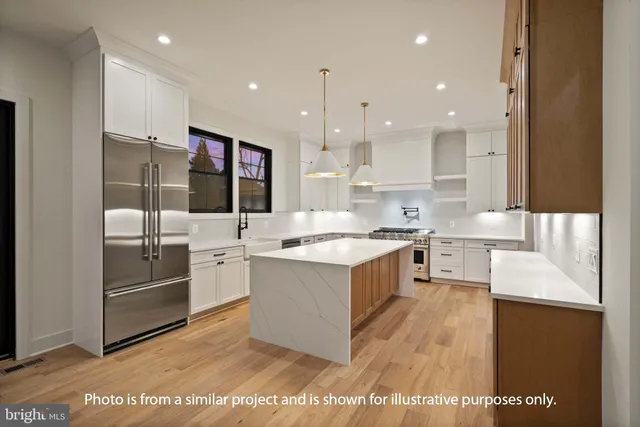a large kitchen with stainless steel appliances kitchen island granite countertop a sink and cabinets