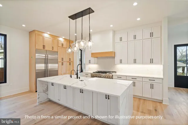 a kitchen with a sink appliances and cabinets