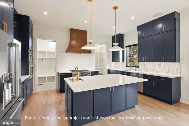 a large kitchen with stainless steel appliances a stove center island a refrigerator and a view of living room