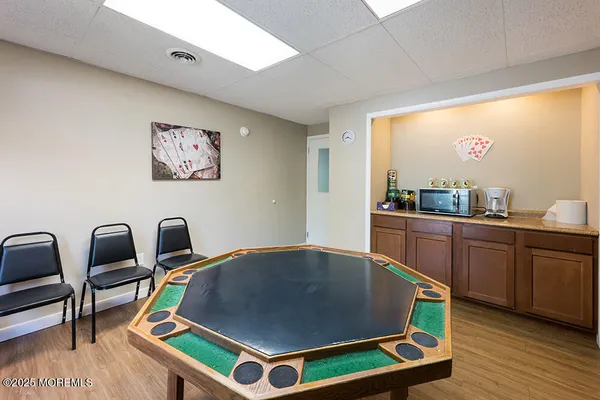 a room with furniture pool table and wooden floor