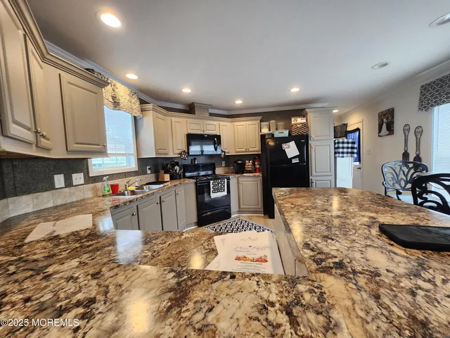 a spacious bedroom with a bed and wooden floor