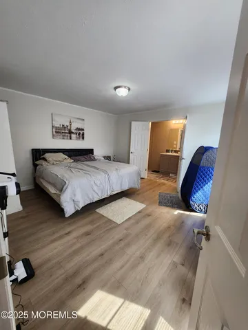 a bathroom with a sink a toilet a mirror and a shower