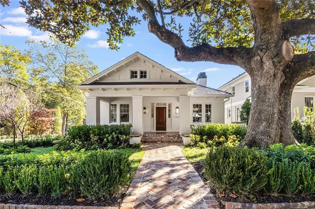 a front view of a house with garden