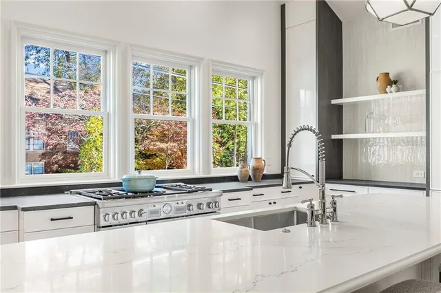 a kitchen with a sink and a large window