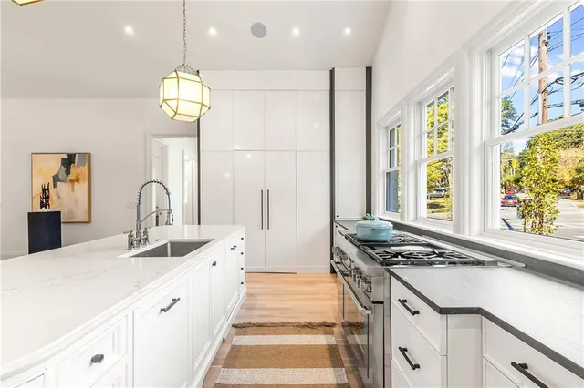 a kitchen with stainless steel appliances granite countertop a stove a sink and a refrigerator