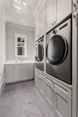 a bathroom with a sink a washer and dryer