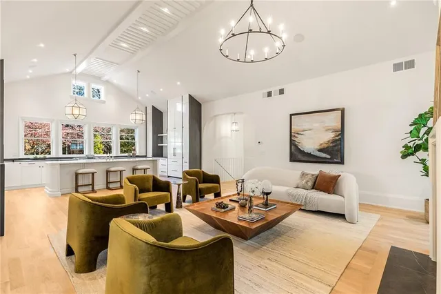 a living room with furniture and a chandelier