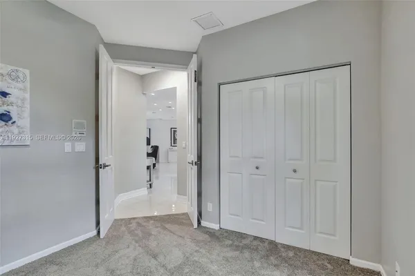 a kitchen with granite countertop a refrigerator and a sink