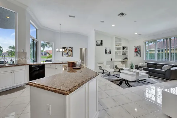 a living room with furniture a fireplace and a window