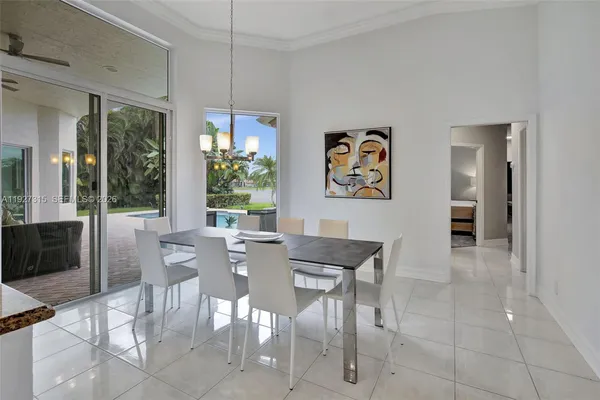 a living room with furniture kitchen view and a flat screen tv