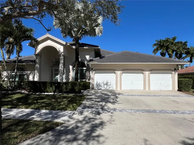 a yellow house with trees in front of it