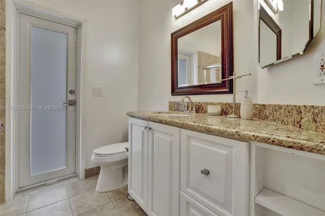 a spacious bathroom with a tub sink and mirror