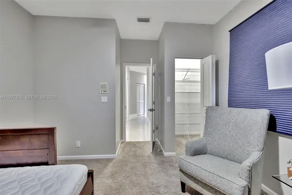 a bedroom with a bed and a couch