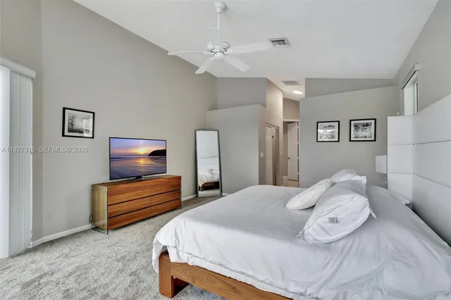 an aerial view of residential houses with outdoor space and lake view