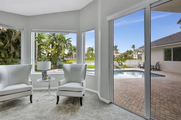 a view of a house with backyard porch and sitting area