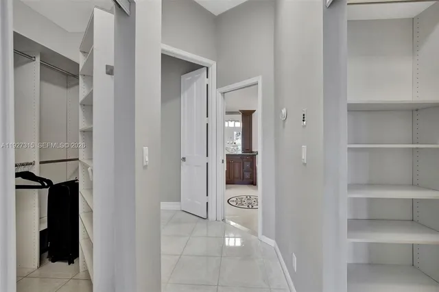 an aerial view of a city with lots of residential buildings ocean and mountain view in back