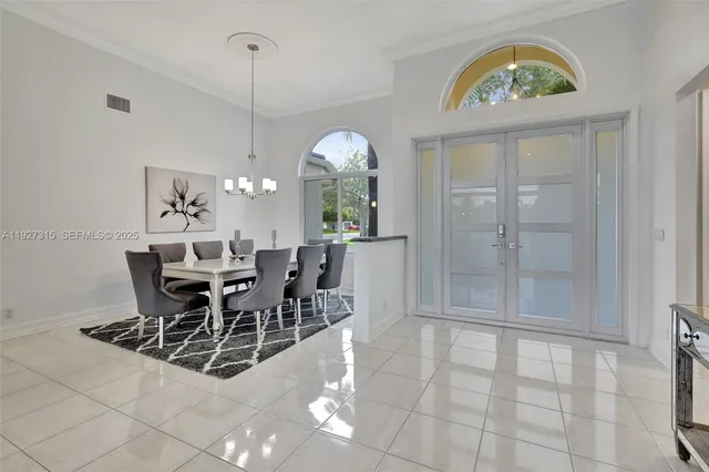 a view of a dining room with furniture and chandelier