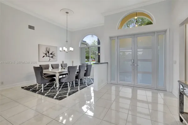 a view of a dining room with furniture and chandelier