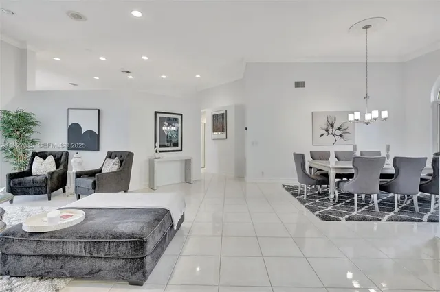 a living room with furniture and a chandelier
