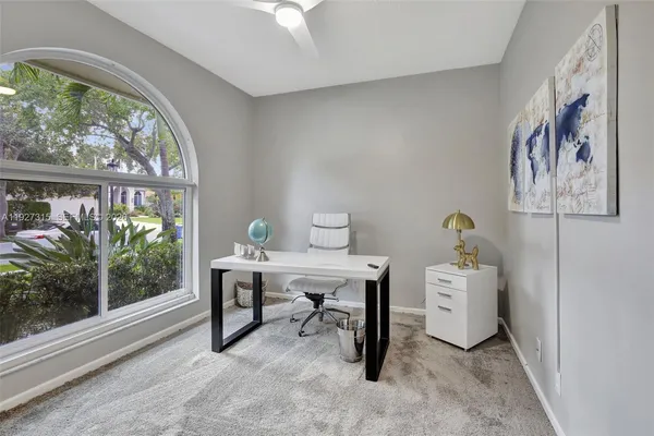 a kitchen with granite countertop a sink and white cabinets