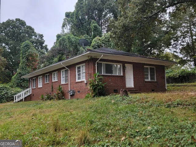 a view of a house with yard and a garden