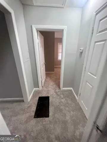 a view of an empty room and stairs