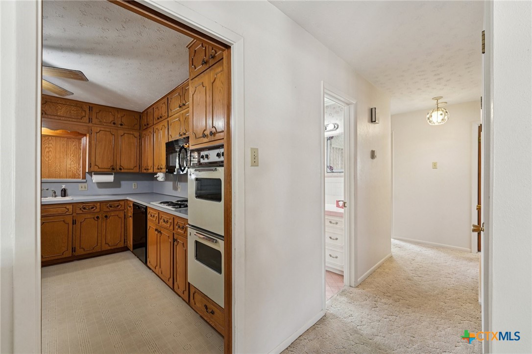 2205 South 53rd Street Temple, TX 76504 - Photo 12 of 44 a large kitchen with cabinets and stainless steel appliances