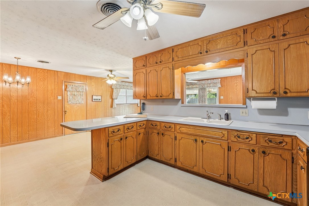 2205 South 53rd Street Temple, TX 76504 - Photo 13 of 44 a large kitchen with cabinets and wooden floor