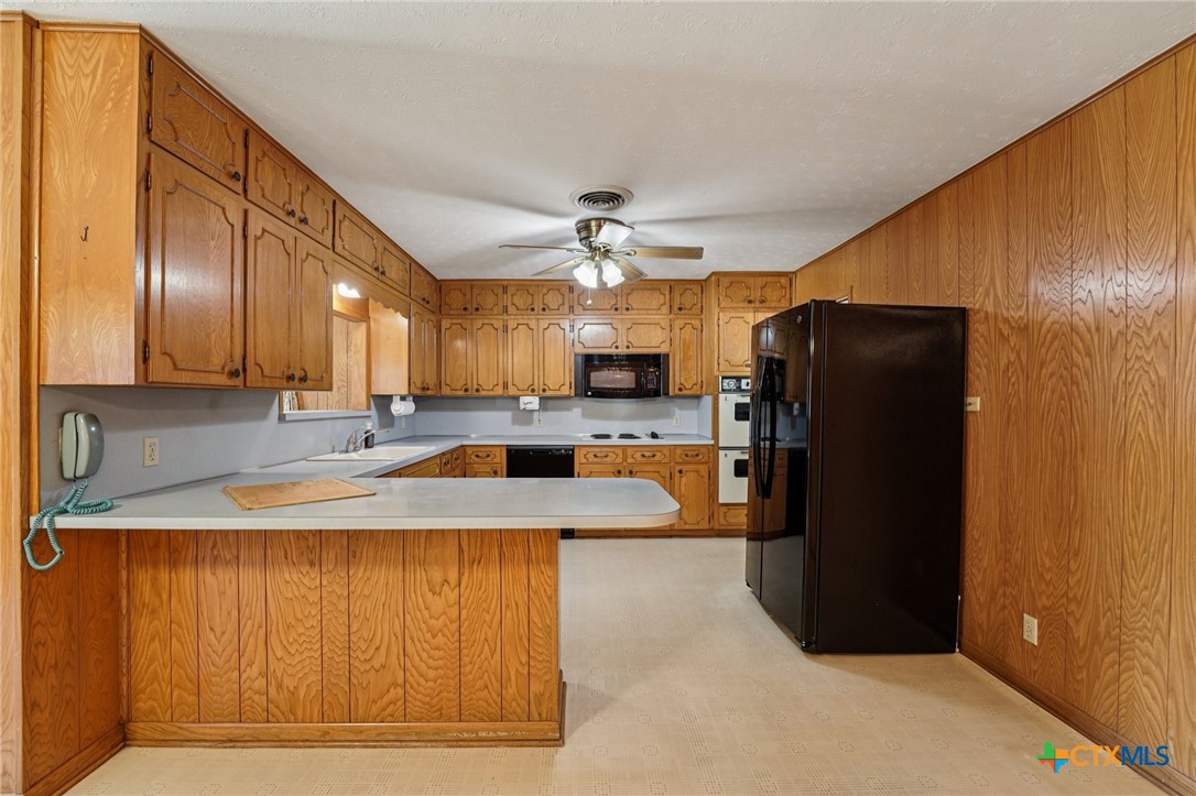 2205 South 53rd Street Temple, TX 76504 - Photo 15 of 44 a large kitchen with stainless steel appliances granite countertop a refrigerator a oven and a sink with granite countertops