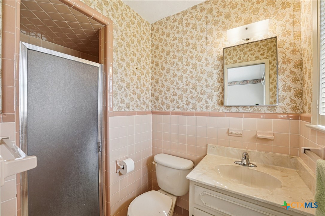 2205 South 53rd Street Temple, TX 76504 - Photo 24 of 44 a bathroom with a toilet sink and mirror