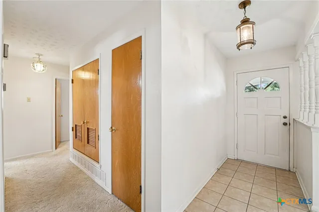 a view of bathroom with a shower and mirror