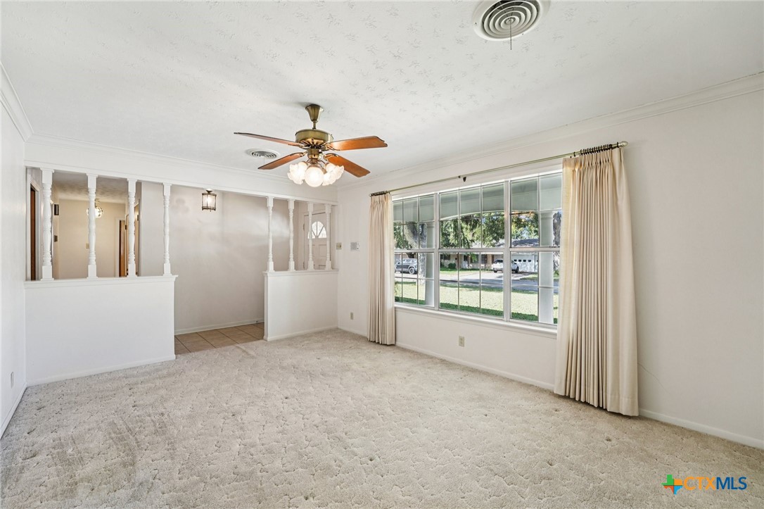 2205 South 53rd Street Temple, TX 76504 - Photo 9 of 44 an empty room with windows and ceiling fan
