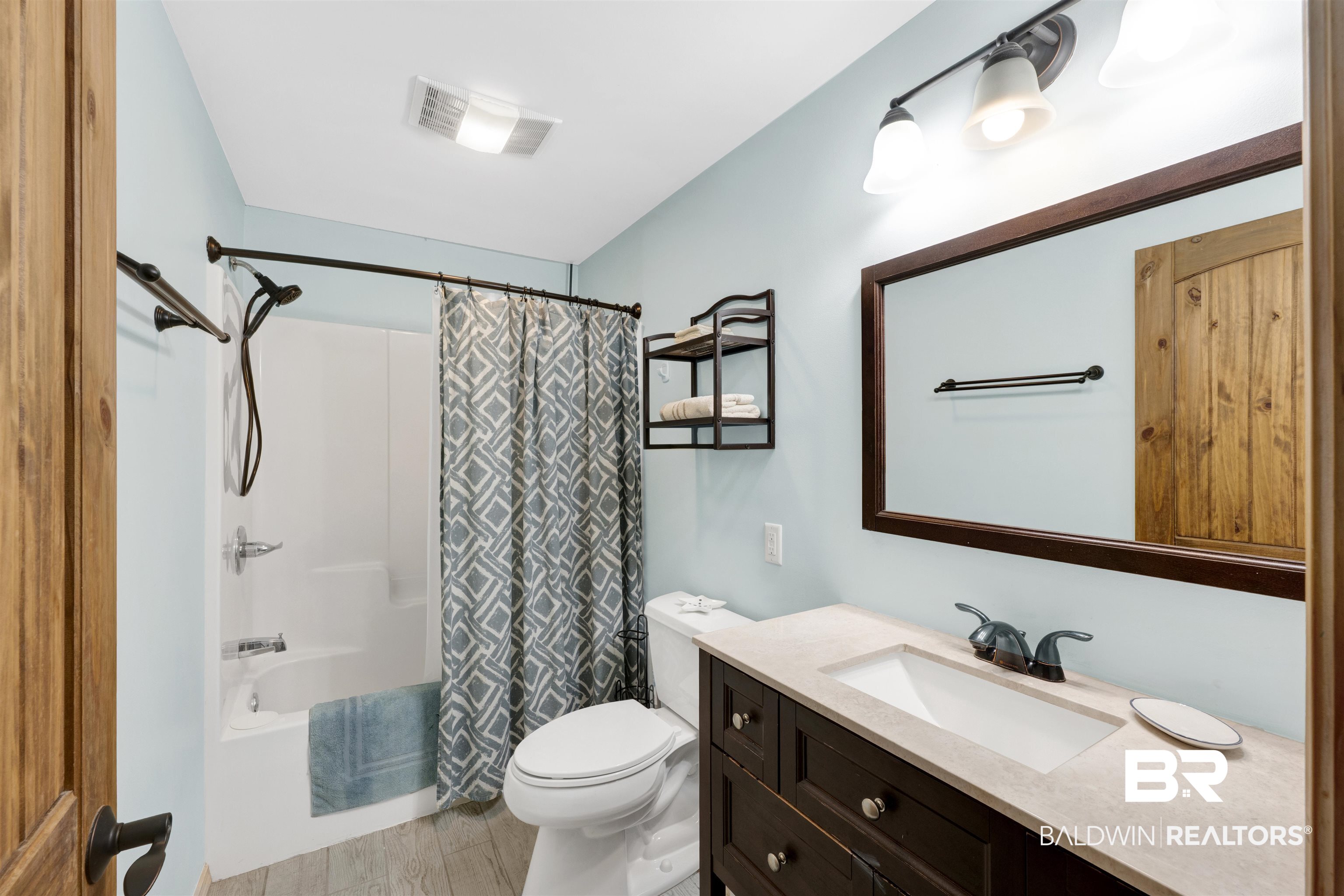 23770 Miflin Road Elberta, AL 36530 - Photo 32 of 38 Full bathroom featuring shower / bath combination with curtain, vanity, and light wood-style floors
