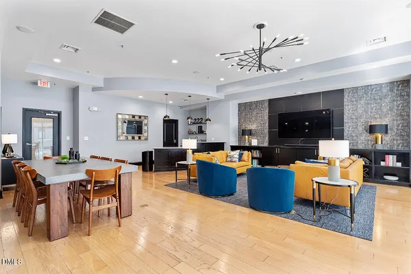 a living room with furniture kitchen view and a large window