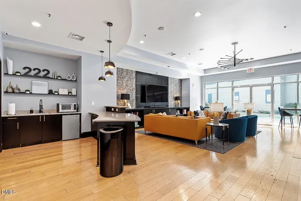 a living room filled with furniture and a chandelier