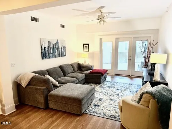 a living room with furniture ceiling fan and a rug