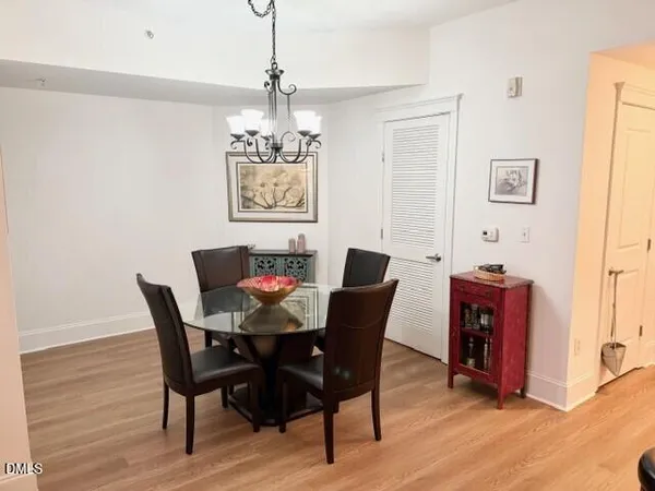 a view of a dining room with furniture wooden floor and a chandelier