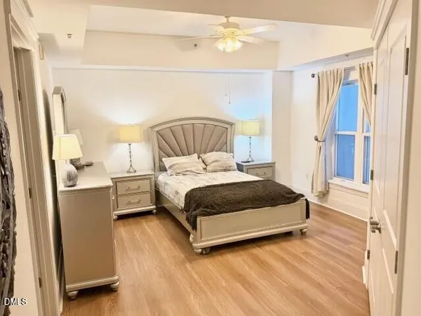 a bedroom with a bed and a mirror
