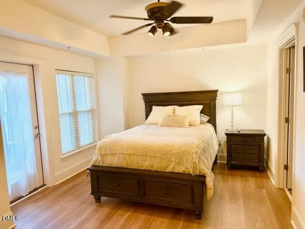 a bedroom with a bed and wooden floor