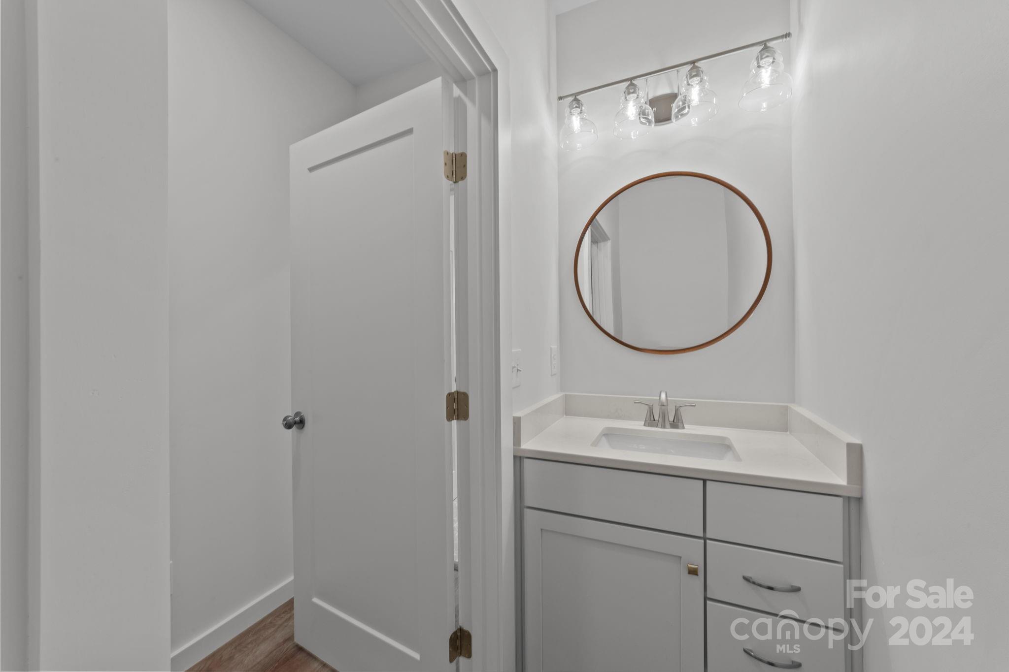 220 Linker Road Rockwell, NC 28138 - Photo 35 of 48 a bathroom with a sink and a mirror
