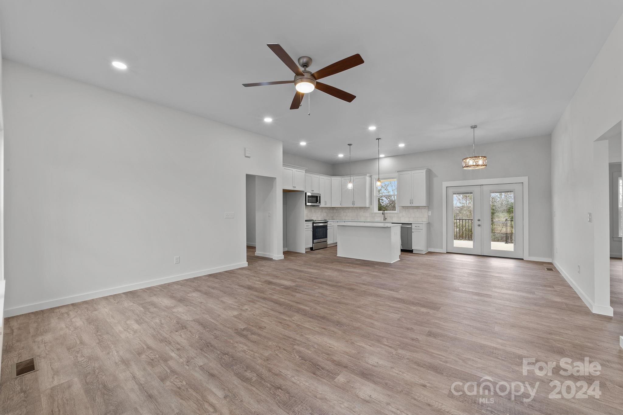 220 Linker Road Rockwell, NC 28138 - Photo 8 of 48 a view of a livingroom with a ceiling fan & kitchen view