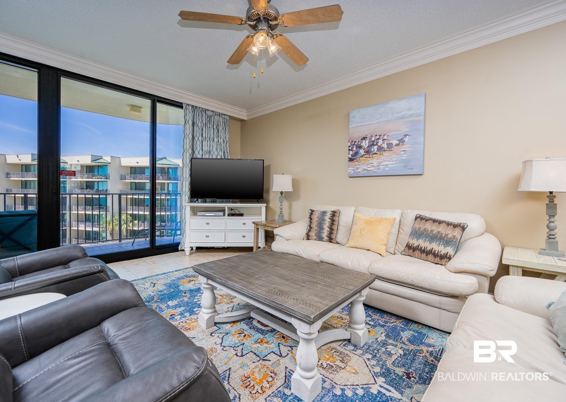 27580 Canal Road, Unit 1429 Orange Beach, AL 36561 - Photo 3 of 45 Tiled living room featuring ornamental molding, floor to ceiling windows, ceiling fan, and a textured ceiling