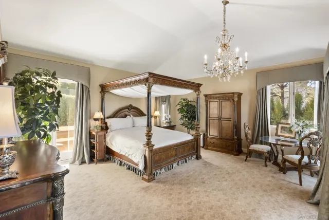 a bed sitting in a spacious bedroom next to a window